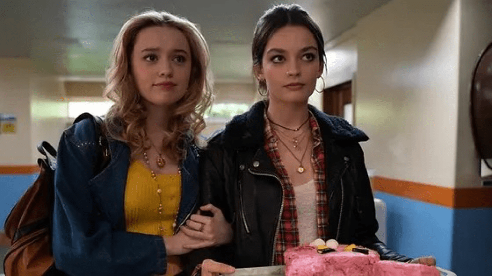 Aimee y Maeve agarradas del brazo en el instituto.